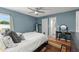 A spacious bedroom with wood flooring, ensuite bathroom, and a large window offering natural light at 3232 Butterfield St, Deltona, FL 32738
