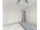 Bedroom with closet and doorway to another room, neutral walls and ceiling fan at 3232 Butterfield St, Deltona, FL 32738