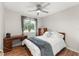 Comfortable bedroom with ceiling fan, desk, wood floors, and outside view at 3232 Butterfield St, Deltona, FL 32738