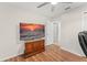 Bedroom with wood floors and a tv, access to the ensuite bathroom at 3232 Butterfield St, Deltona, FL 32738