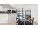 Cozy dining area features a glass table, black chairs, and a sliding door offering backyard views at 3232 Butterfield St, Deltona, FL 32738