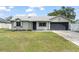 Charming one story home with a well-maintained lawn, gray exterior, and a two-car garage at 3232 Butterfield St, Deltona, FL 32738