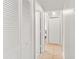 Hallway with tile flooring, multiple doors, and white paint at 3232 Butterfield St, Deltona, FL 32738
