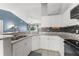 A modern kitchen with white cabinets, granite countertops, and stainless steel appliances at 3232 Butterfield St, Deltona, FL 32738