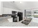 Well-lit kitchen with granite counters, white cabinets, and a sliding door leading to the backyard pool at 3232 Butterfield St, Deltona, FL 32738