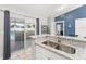 Kitchen area featuring a stainless steel sink, granite countertops and view to outdoor pool through sliding glass doors at 3232 Butterfield St, Deltona, FL 32738