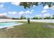 Fenced backyard with a swimming pool and green grass at 3232 Butterfield St, Deltona, FL 32738