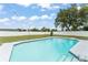 Large in-ground pool with a fenced backyard and string lights at 3232 Butterfield St, Deltona, FL 32738