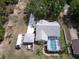 Aerial view of a property with a camper, screened pool, and a well-maintained yard at 32937 Scenic Hills Dr, Mount Dora, FL 32757