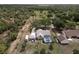 Expansive aerial view of a house with a screened pool and lush green surroundings at 32937 Scenic Hills Dr, Mount Dora, FL 32757