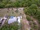 Aerial view of the home, pool, spacious yard, and surrounding trees at 32937 Scenic Hills Dr, Mount Dora, FL 32757