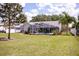 Beautiful backyard with screened pool and lush landscaping at 32937 Scenic Hills Dr, Mount Dora, FL 32757