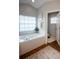 Large tub in this bathroom receives lots of natural light from the window at 32937 Scenic Hills Dr, Mount Dora, FL 32757