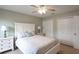 Comfortable bedroom with large bed and ceiling fan at 32937 Scenic Hills Dr, Mount Dora, FL 32757