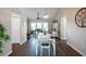 Bright dining area featuring wood floors, modern pendant lighting, and a view into the living room at 32937 Scenic Hills Dr, Mount Dora, FL 32757
