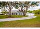 Charming single-story home with an extended driveway and attached garage at 32937 Scenic Hills Dr, Mount Dora, FL 32757