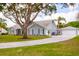 Inviting home with well-manicured lawn, long driveway, and large garage at 32937 Scenic Hills Dr, Mount Dora, FL 32757