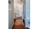 Hallway with wood floors that leads to a bathroom with shower and tub at 32937 Scenic Hills Dr, Mount Dora, FL 32757