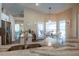 Modern kitchen with stainless steel appliances, granite countertops, and a breakfast bar overlooking the dining area at 32937 Scenic Hills Dr, Mount Dora, FL 32757