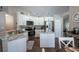 Stylish kitchen with white cabinetry, stainless steel appliances, and center island, perfect for culinary enthusiasts at 32937 Scenic Hills Dr, Mount Dora, FL 32757