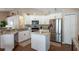 Well-equipped kitchen featuring granite countertops, stainless steel appliances, and a functional center island for meal prep at 32937 Scenic Hills Dr, Mount Dora, FL 32757
