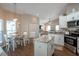 Bright eat-in kitchen with island, stainless appliances, and wood flooring at 32937 Scenic Hills Dr, Mount Dora, FL 32757