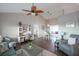 Open-concept living room showcasing an elegant desk area, dining space, and seamless flow to the kitchen at 32937 Scenic Hills Dr, Mount Dora, FL 32757