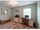 Bright office space with a window, desk, and patterned rug at 32937 Scenic Hills Dr, Mount Dora, FL 32757