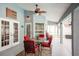 Inviting covered patio with comfortable seating, ceiling fan, and serene outdoor dining space at 32937 Scenic Hills Dr, Mount Dora, FL 32757