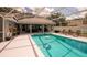 Sparkling screened-in pool surrounded by ample deck space and lush landscaping, ideal for relaxation at 32937 Scenic Hills Dr, Mount Dora, FL 32757
