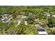 Aerial view of a modern home nestled among lush greenery with a manicured lawn at 3672 Rollin O Ln, Apopka, FL 32703