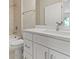 A nicely appointed bathroom has a granite countertop, white cabinets and white tile at 3672 Rollin O Ln, Apopka, FL 32703