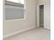 This bedroom has neutral carpet, a frosted window, and a double door closet at 3672 Rollin O Ln, Apopka, FL 32703