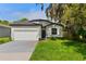 Charming single-story home with a well-maintained lawn, a two-car garage, and curb appeal at 3672 Rollin O Ln, Apopka, FL 32703