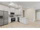 Well-lit kitchen boasts stainless steel appliances, white cabinets and countertop, and new laminate flooring at 3672 Rollin O Ln, Apopka, FL 32703