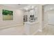 Open-concept kitchen with white cabinetry, stainless steel appliances, and laminate flooring at 3672 Rollin O Ln, Apopka, FL 32703