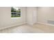 Bright living room featuring laminate flooring, a large window with natural light, and a white front door at 3672 Rollin O Ln, Apopka, FL 32703