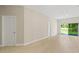 A bright living room features wood floors, neutral walls, white trim and three doors at 3672 Rollin O Ln, Apopka, FL 32703