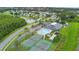 Aerial view of the community amenities including a pool, tennis courts, and clubhouse at 3813 Blue Dasher Dr, Kissimmee, FL 34744