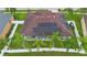 Aerial view of the house with solar panels, backyard, palm trees, and a white fence at 3813 Blue Dasher Dr, Kissimmee, FL 34744