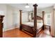 Spacious bedroom with four-poster bed, wood floors and light-filled windows at 3813 Blue Dasher Dr, Kissimmee, FL 34744