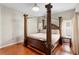 Bright bedroom with four-poster bed, wood floors and light-filled windows at 3813 Blue Dasher Dr, Kissimmee, FL 34744