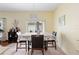 Breakfast nook with table and chairs, elegant chandelier, and view of the backyard through sliding glass doors at 3813 Blue Dasher Dr, Kissimmee, FL 34744