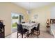 Cozy dining area with chandelier, sliding glass doors leading to backyard, seats four at 3813 Blue Dasher Dr, Kissimmee, FL 34744