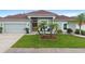 Charming home with a well-kept lawn, red front door, and a two-car garage at 3813 Blue Dasher Dr, Kissimmee, FL 34744