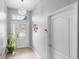 Inviting home foyer featuring tile flooring, a glass front door, and a modern chandelier at 3813 Blue Dasher Dr, Kissimmee, FL 34744