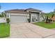 Attractive single-story house showcases a well-maintained lawn and a spacious two-car garage at 3813 Blue Dasher Dr, Kissimmee, FL 34744