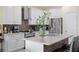 Modern kitchen features stainless appliances, a central island with bar seating, and ample countertop space at 3813 Blue Dasher Dr, Kissimmee, FL 34744