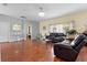 Open-concept living room with wood flooring, modern decor, and comfortable seating at 3813 Blue Dasher Dr, Kissimmee, FL 34744