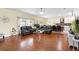 Open-concept living space with wood floors seamlessly connecting the living, dining, and kitchen areas at 3813 Blue Dasher Dr, Kissimmee, FL 34744
